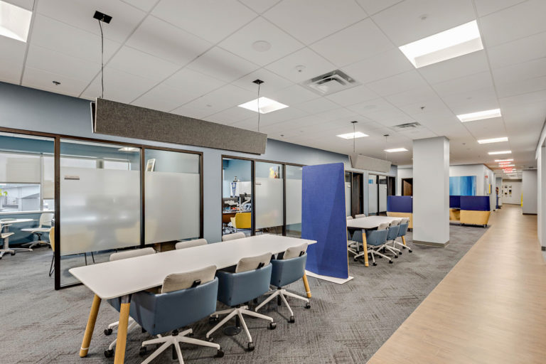 Modern office interior with conference tables and partition panels, renovated by LAY Construction.