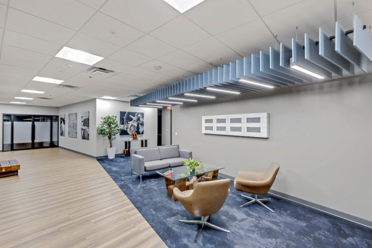 Modern commercial office lobby with contemporary design and acoustic ceiling panels.