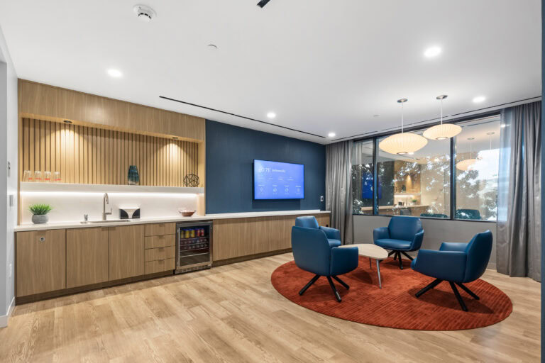 Contemporary living room with modern furniture, wood flooring, and large windows at LAY Construction.