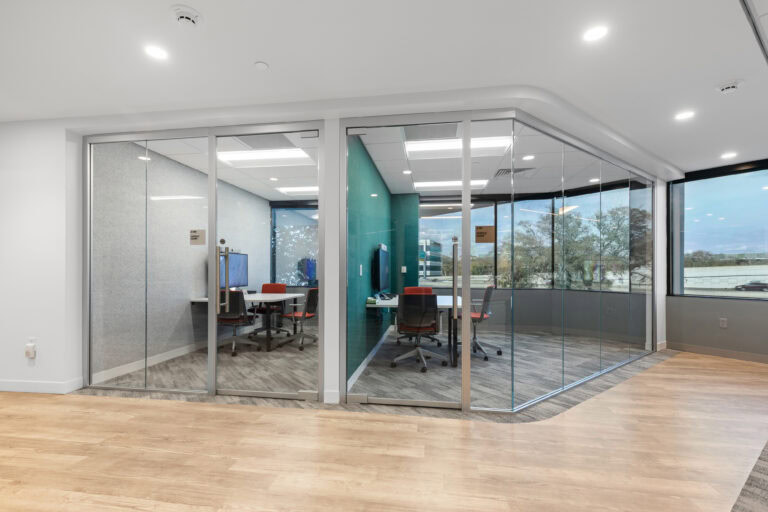 Modern office conference room with glass walls and contemporary interior design.