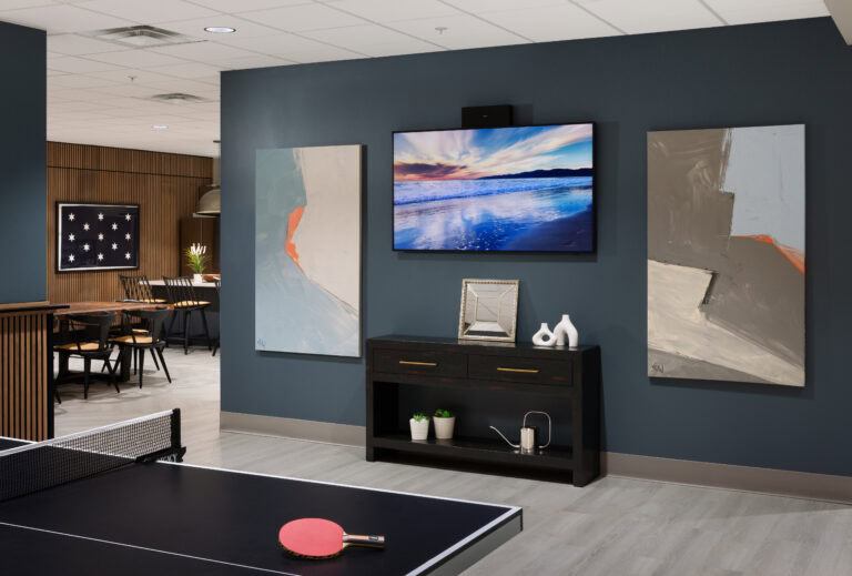 Luxury indoor recreational space featuring modern decor, artwork, and ping pong table by LAY Construction.