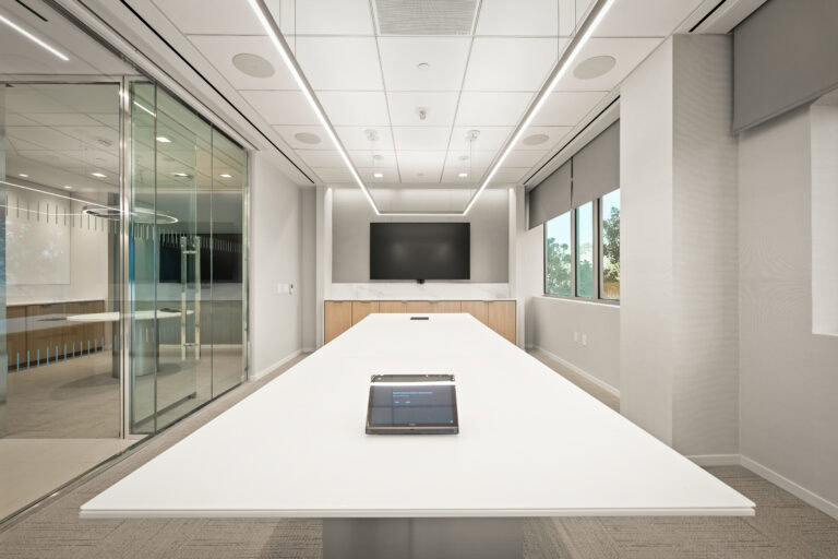 Modern corporate conference room with sleek design and natural light, ideal for professional meetings.